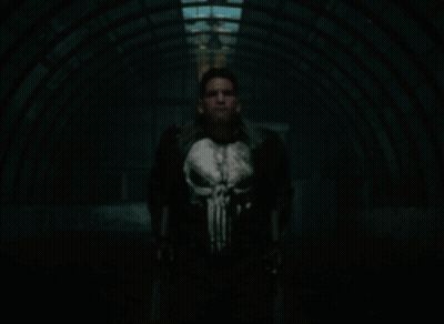 Man In Punisher Costume Holding Guns GIF
