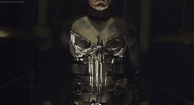 Man In Punisher Costume In Dark Room GIF