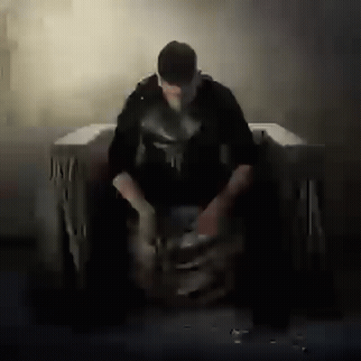 Man In Punisher Costume Sitting GIF
