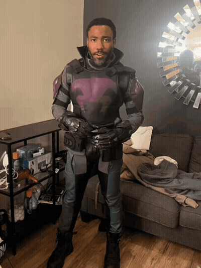 Man In Purple And Black Suit Facing Mirror GIF