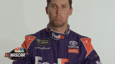 Man In Purple And Orange Racing Suit Making Face GIF