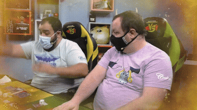 Man In Purple Cat Shirt Next To Masked Man GIF