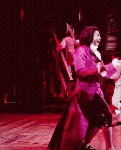 Man In Purple Coat Dancing On Stage GIF