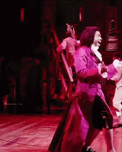 Man In Purple Coat Dancing On Stage GIF