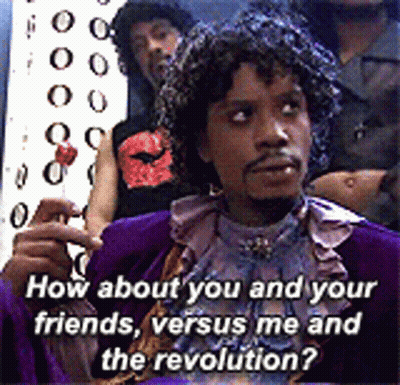 Man In Purple Costume Holding Lollipop Asking How About You And Your Friends Versus Me And The Revolution GIF