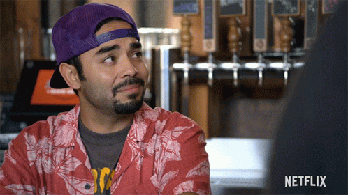 Man In Purple Hat And Red Shirt With Netflix Logo GIF