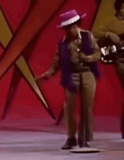 Man In Purple Hat Dancing At Microphone GIF