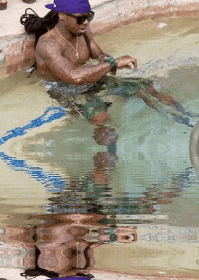 Man In Purple Hat Sitting In Swimming Pool GIF