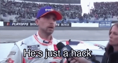 Man In Purple Hat Talking Into Microphone Woman Behind GIF