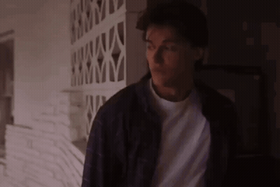 Man In Purple Jacket And White Shirt In Dark Room GIF