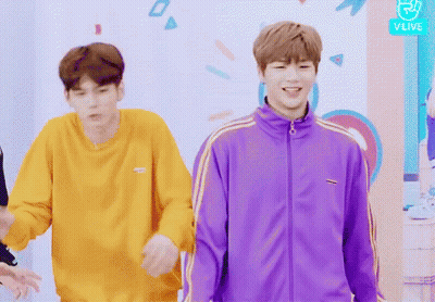 Man In Purple Jacket Next To Man In Yellow Sweatshirt GIF
