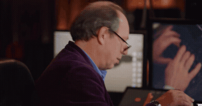 Man In Purple Jacket Sitting At Computer GIF