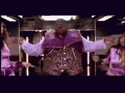 Man In Purple Jacket Standing With Arms Out GIF
