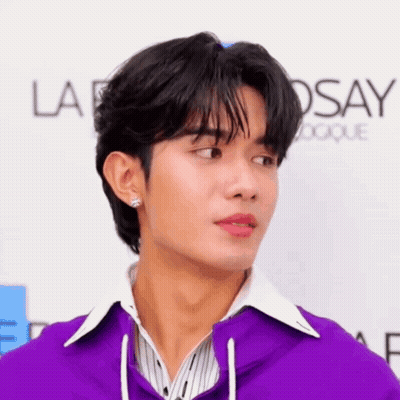 Man In Purple Jacket White Shirt At La Roche Posay Sign GIF