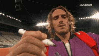 Man In Purple Jacket Writing With Marker In Front Of Eurosport Logo GIF