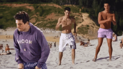 Man In Purple Moon Sweatshirt On Sandy Beach GIF