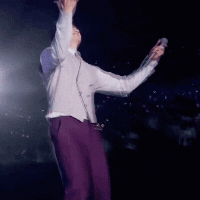 Man In Purple Pants Holding Microphone GIF