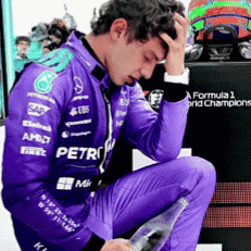 Man In Purple Racing Suit Kneeling Holding Water GIF