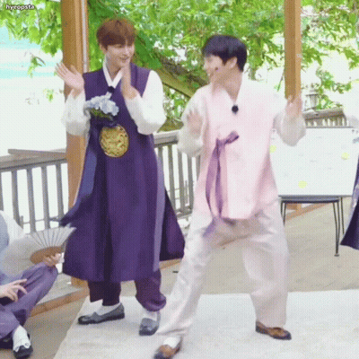 Man In Purple Robe Next To Man In Pink Robe GIF