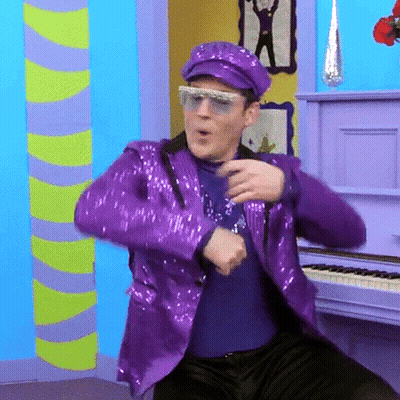 Man In Purple Sequined Suit Dancing By Piano GIF