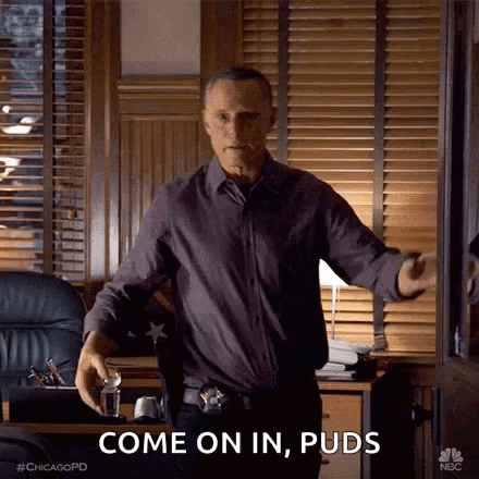 Man In Purple Shirt And Black Pants Talking In Office GIF