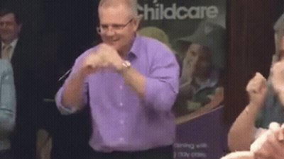 Man In Purple Shirt And Glasses Dancing At Childcare Sign GIF