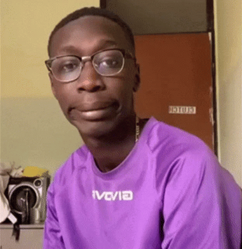 Man In Purple Shirt And Glasses Looking At Camera GIF