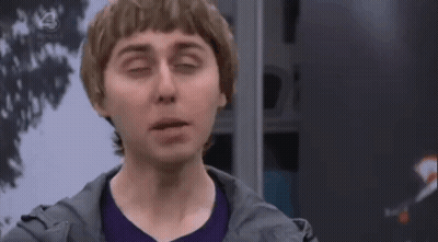 Man In Purple Shirt And Gray Jacket Making Funny Face GIF