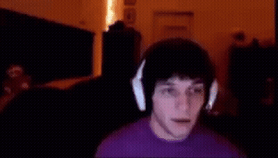 Man In Purple Shirt And Headphones At Computer GIF