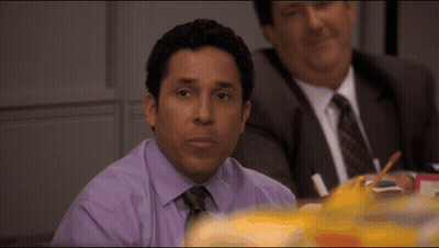 Man In Purple Shirt And Tie At Table GIF