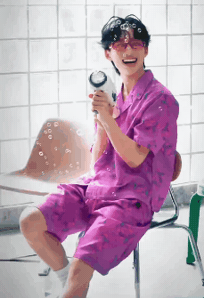 Man In Purple Shirt Blowing Bubbles GIF