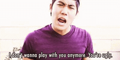 Man In Purple Shirt Blue Shorts Brick Wall GIF