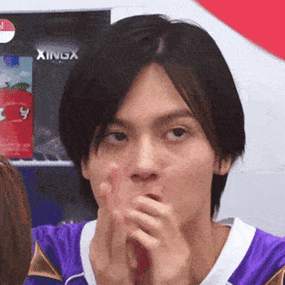 Man In Purple Shirt Covering Mouth With Xingx Sign GIF