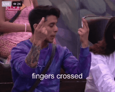 Man In Purple Shirt Giving Middle Finger Saying Fingers Crossed GIF