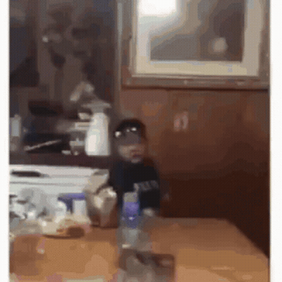 Man In Purple Shirt Hands On Hips Kitchen GIF