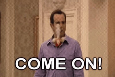 Man in Purple Shirt Holding Remote Saying Come On