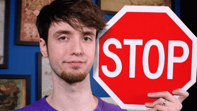 Man In Purple Shirt Holding Stop Sign GIF
