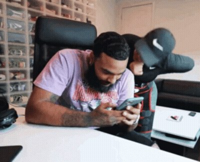 Man In Purple Shirt Looking At Cellphone GIF