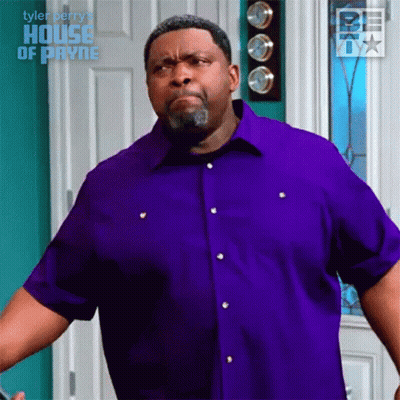 Man In Purple Shirt Making Face In Front Of Door GIF
