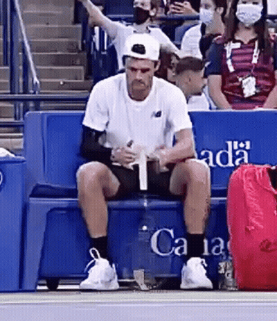 Man In Purple Shirt On Tennis Court In Front Of Emirates Sign GIF