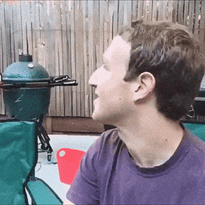 Man In Purple Shirt Sits In Front Of Green Egg Grill GIF