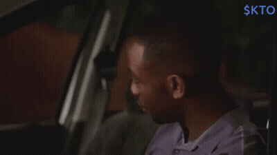 Man In Purple Shirt Sitting In Back Seat With Word Skto GIF
