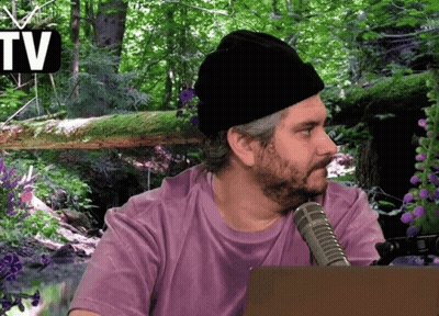 Man In Purple Shirt Sitting In Front Of TV Sign GIF