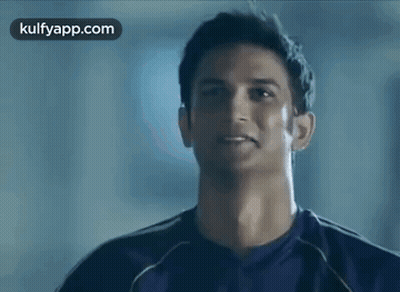 Man In Purple Shirt Smiling At Camera GIF