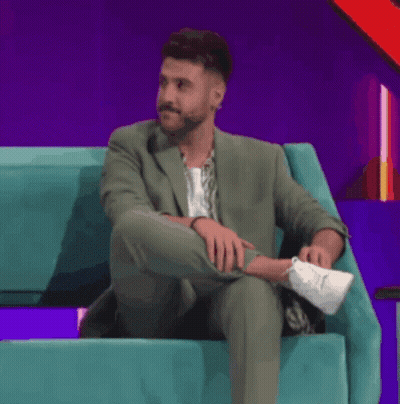 Man In Purple Shirt Smiling At Sugar Sign GIF