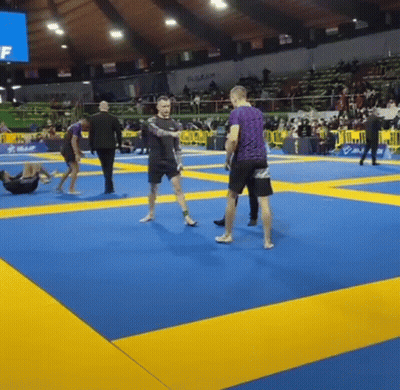 Man In Purple Shirt Standing On Boxing Ring Mat GIF