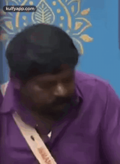 Man In Purple Shirt Talking On Cell Phone GIF