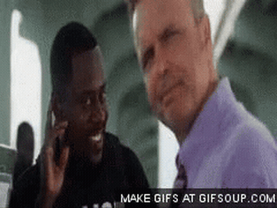 Man In Purple Shirt Talking On Phone With Another GIF