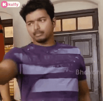 Man In Purple Striped Shirt At Door Looking At Camera GIF