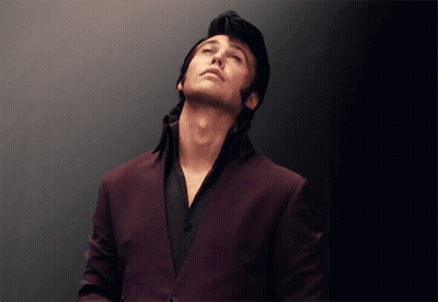 Man In Purple Suit And Black Shirt Looking Up GIF